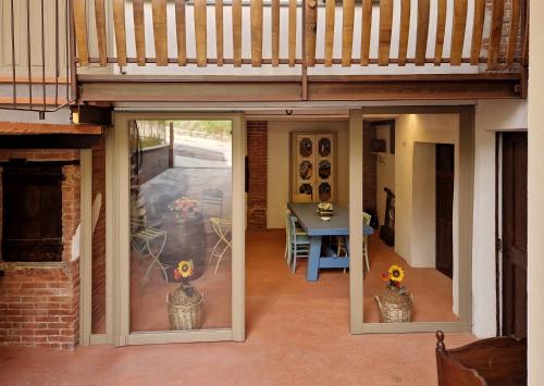 a sliding glass door leading to a patio with a table at Mister Barolo Apartments Langhe in Novello