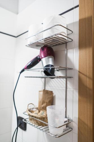 a shelf with a lamp and a basket and books at La Cantinota - Locanda De Manincor Rooms in Arco