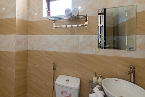 a bathroom with a toilet and a sink and a mirror at Hoi An Blue River Hotel in Hoi An