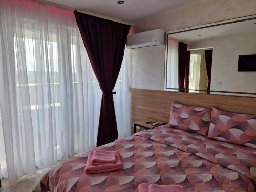 a bedroom with a large bed and a mirror at Rooms Green Set in Belgrade