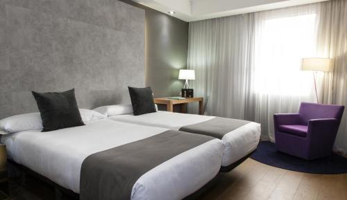 מיטה או מיטות בחדר ב-Zenit Conde de Orgaz