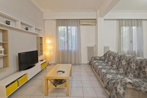 A television and/or entertainment centre at Mavili Square Cozy Apt AC & Kitchen, near Metro