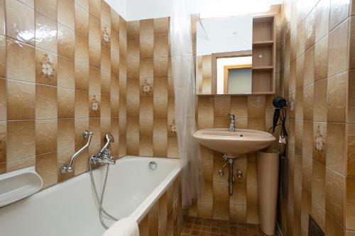 a bathroom with a sink and a bath tub and a sink at A spacious 3-bedroom apartment with king-size beds is located within 5 minute’s walk from the Prater in Vienna