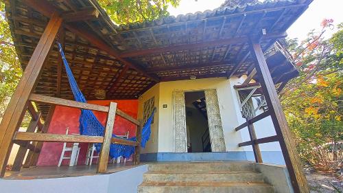 a house with a staircase leading up to the door at Stay Cool Pipa in Pipa