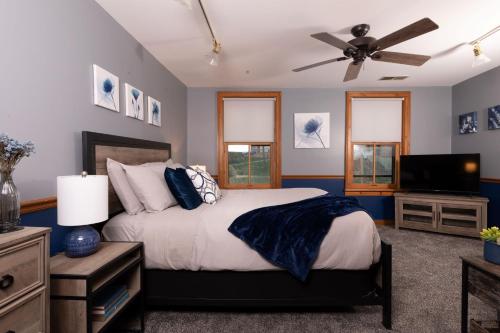 a bedroom with a bed and a ceiling fan at Riverboat Suites in Galena