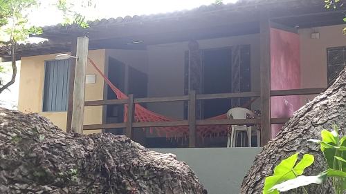 a house with a fence and a table on the porch at Stay Cool Pipa in Pipa