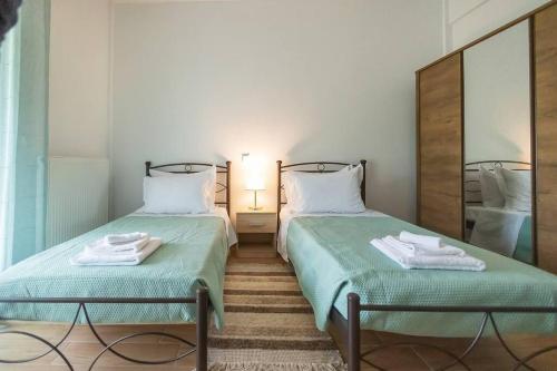 two beds sitting next to each other in a room at Elpida's country house in Lefkimmi