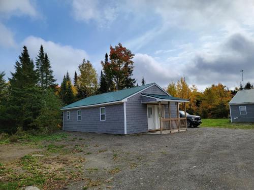 a small house in a parking lot at Katahdin's Shadow Lodge in Linneus