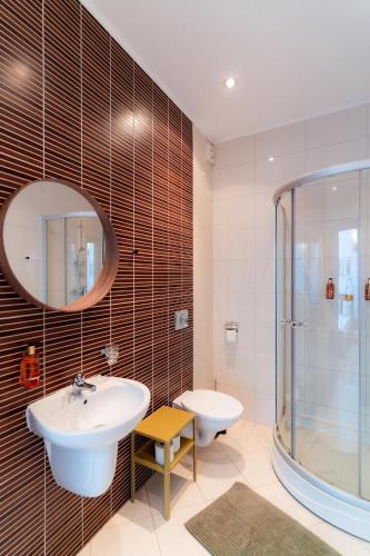 a bathroom with a sink and a shower at Rezident Eforie Nord in Eforie Nord