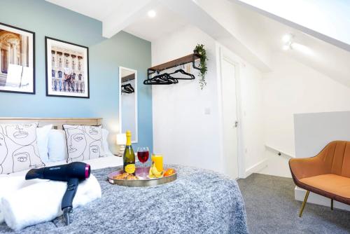 a bedroom with a bed and a table with wine glasses at Central Buckingham Apartment #8 with Free Parking, Pool Table, Fast Wifi and Smart TV with Netflix by Yoko Property in Buckingham