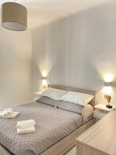 a bedroom with a bed with two towels on it at Paolina Home in La Spezia