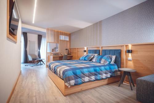 a bedroom with a bed and a desk and a chair at Il Sogno in Avio