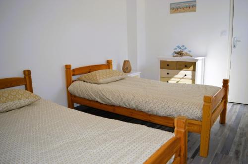 - une chambre avec 2 lits et une commode dans l'établissement La Guillaumière - Maison avec bel extérieur, à Cresserons
