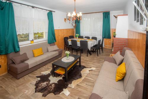 a living room with a couch and a table at Otthon A Pagonyban in Mátraszentimre