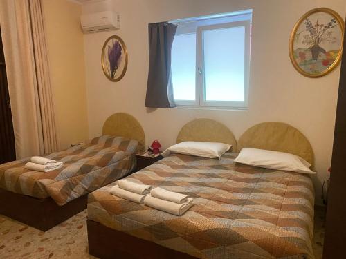 two beds in a room with a window at B&B Anna Fiera in Verona