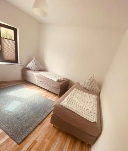 a room with a bed and a couch and a window at Ferienwohnung Horst 2 in Nordenham