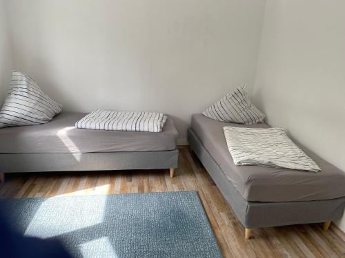 a room with two beds and a couch and a rug at Ferienwohnung Horst 2 in Nordenham