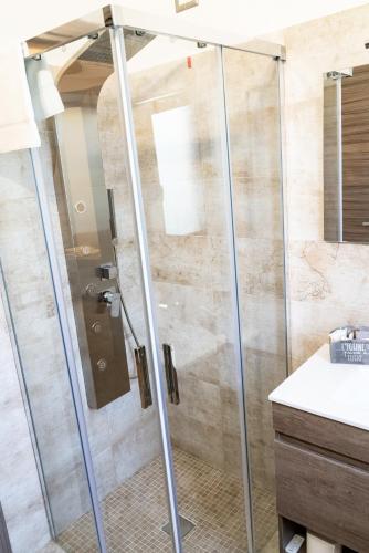 a shower with a glass door in a bathroom at B&B Tenuta Piano Campo in Ucria