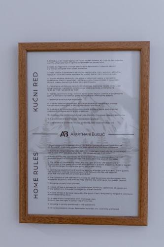 a framed picture of an american database at Apartmani Bijelic in Žabljak