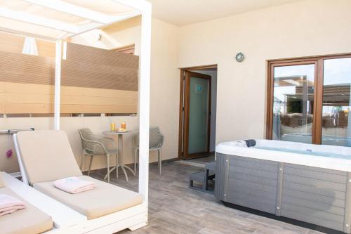 a bathroom with a bath tub and a table at Yianna Caravel "by Checkin" in Amoudara Herakliou