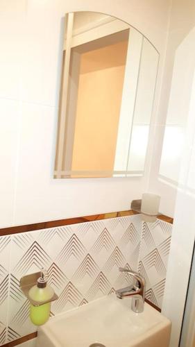 a bathroom with a sink and a mirror at Victory in Stara Zagora