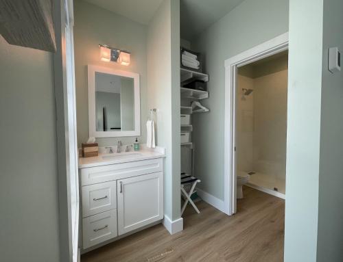 a bathroom with a sink and a mirror at Key West Cottages in Chincoteague
