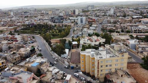 an aerial view of a city with buildings at Fareeq Hotel in Erbil