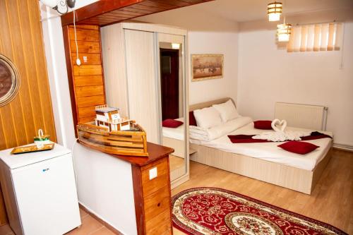 a small room with a bed and a table at Casa Ecaterina 2 Mai in 2 Mai
