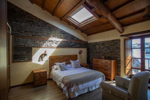 a bedroom with a bed in a room with a window at Casa Ría de Navia in Navia