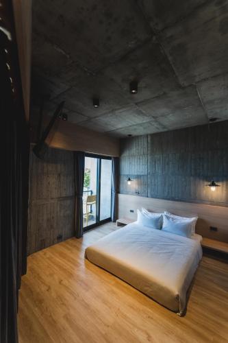 a bedroom with a large bed and a large window at Okkar Inn in Nanwan