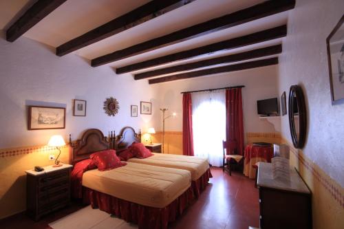 sypialnia z dużym łóżkiem z czerwonymi poduszkami w obiekcie Petit Hotel Ses Rotges - Only Adults w Cala Ratjada