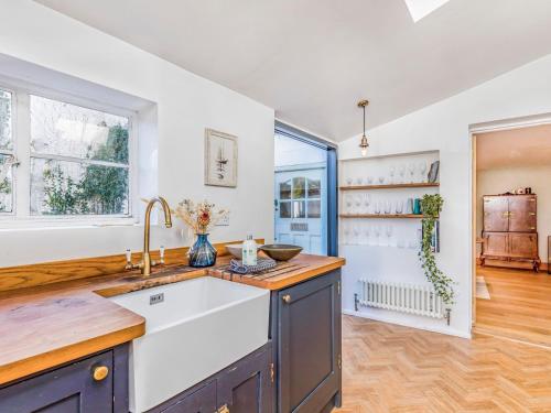 a kitchen with a sink and a window at Charming Downland Cottage - Pass the Keys in Chichester
