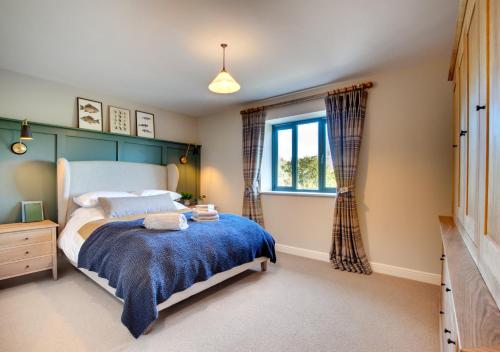 a bedroom with a large bed and a window at Rocks Cottage in Builth Wells