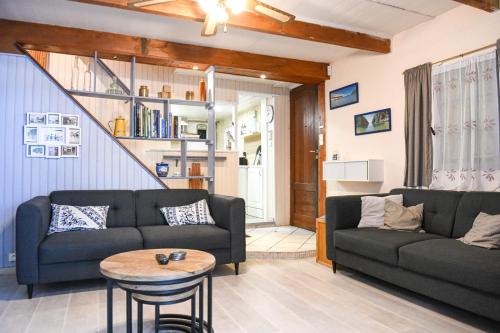 ein Wohnzimmer mit 2 Sofas und einem Tisch in der Unterkunft Le Cabanon - Maison 2 ch avec jardin et parking in Marseille