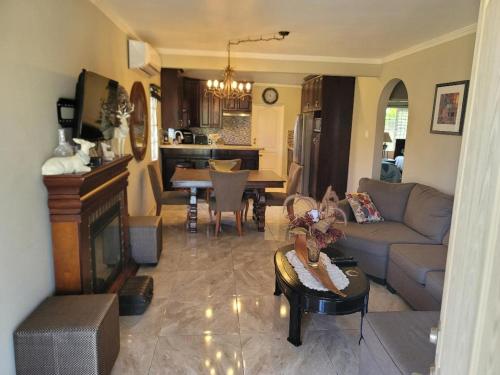 a living room with a couch and a table at Soleil House with a View in Priory