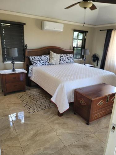 a bedroom with a large bed and two night stands at Soleil House with a View in Priory