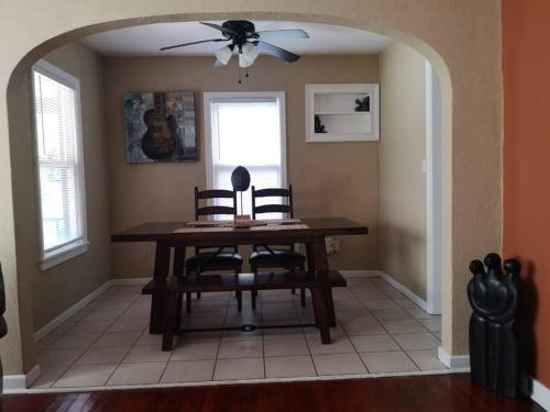 a dining room table with two chairs and a ceiling fan at Bungalow Haven in Winter Haven