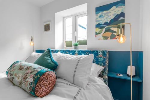 a room with a bed with pillows and a painting at Duke Street brand new central 1 bed flat in Norwich