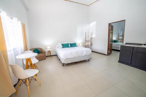 a bedroom with a bed and a table and chairs at Natüra Hotel Monteverde in Monteverde Costa Rica