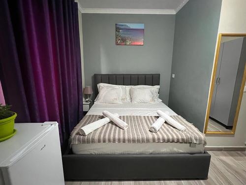 1 dormitorio con 1 cama con 3 almohadas en VILA AARON, en Durrës