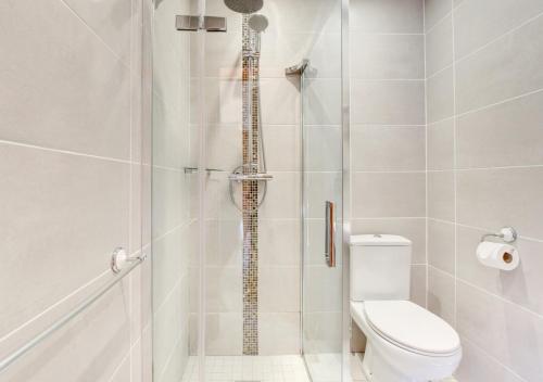 a bathroom with a shower with a toilet at Y Fro - The Vale in Barry