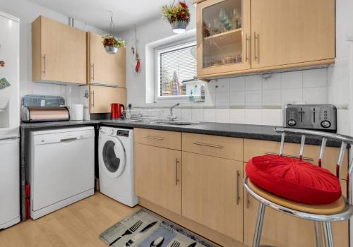 a kitchen with a sink and a washing machine at Valley Rise By My Getaways Free Parking in Portslade