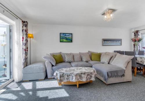a living room with a couch and a table at Valley Rise By My Getaways Free Parking in Portslade