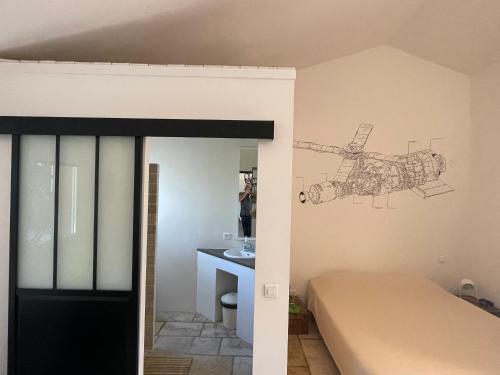 a room with a bed and a drawing on the wall at Oustal du pic saint loup in Saint-Jean-de-Cuculles
