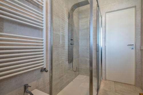a shower with a glass door in a bathroom at The Fetch - Residenze Esclusive sull'Acqua in Alghero