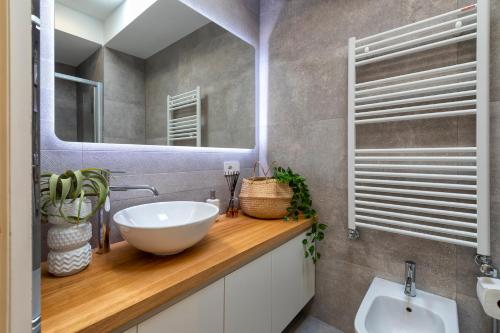 a bathroom with a sink and a mirror at The Fetch - Residenze Esclusive sull'Acqua in Alghero