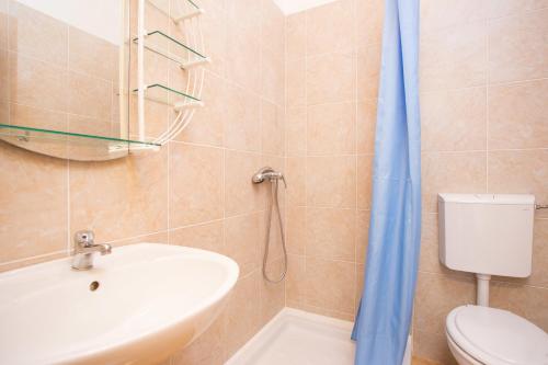 a bathroom with a sink and a toilet at Apartments Adriatic in Selce