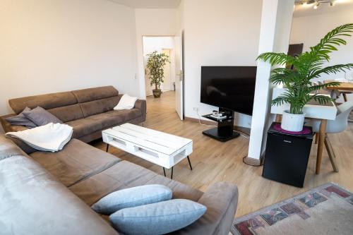 a living room with a couch and a flat screen tv at Fewo Obsthof Matthies in Jork