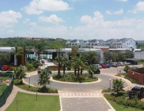 a parking lot with cars parked in front of a building at Joy Apartment@The Blyde in Pretoria