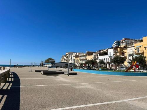 an empty parking lot with buildings and a playground at Mare Azzurro Appartamento in Sciacca